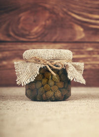 Close-up of capers in jar on table