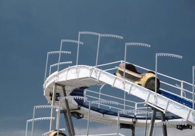 Low angle view of ferris wheel against blue sky