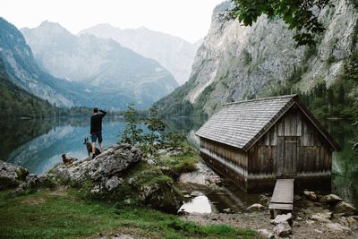 House by mountains against sky