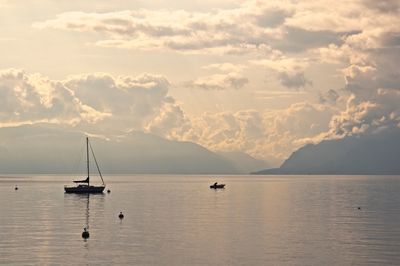 Boats moored in lake against sky