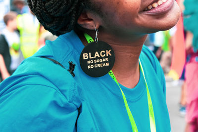 Close-up of smiling woman wearing black earring