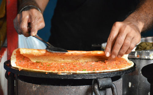 Close-up of man preparing food