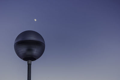 Low angle view of moon against blue sky