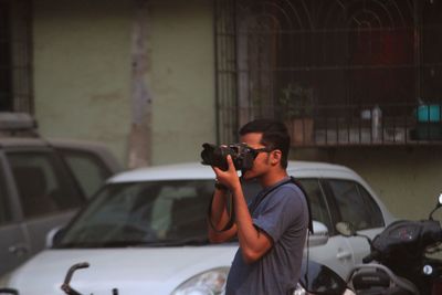 Man photographing in car