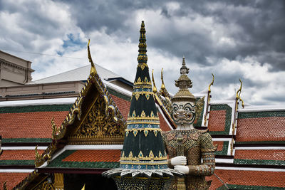 Low angle view of temple building against cloudy sky