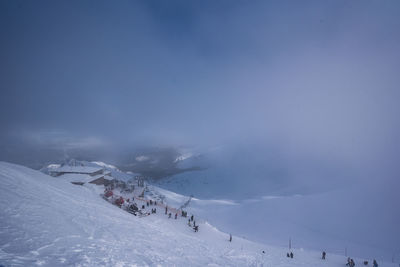 Scenic view of snow covered mountains against sky