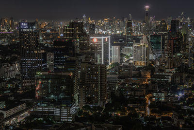 Aerial view of illuminated buildings in city at night