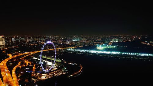 High angle view of illuminated city against clear sky at night
