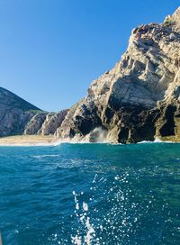 Scenic view of sea against clear blue sky