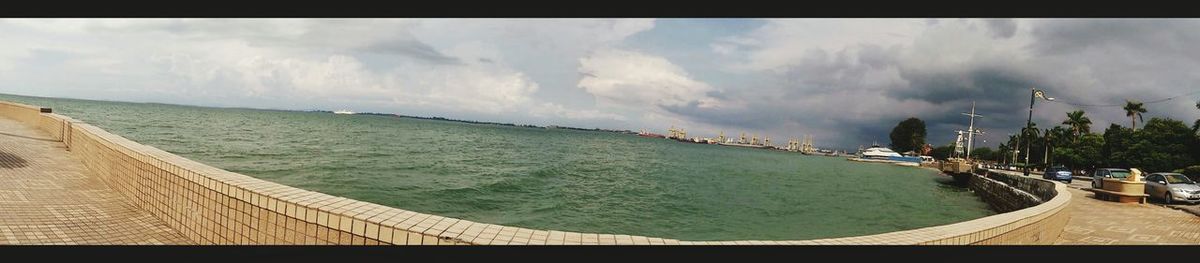 Panoramic view of sea against cloudy sky