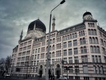 Low angle view of buildings against cloudy sky / yenidze dresden 