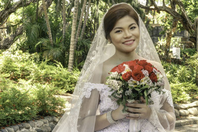 Portrait of bride holding flowers