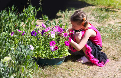 Rear view of woman with pink flowering plants