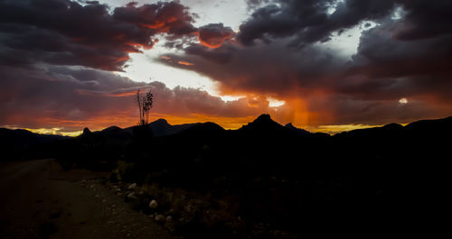 Scenic view of silhouette mountains against sky during sunset