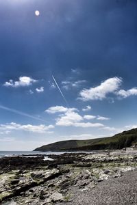 Scenic view of sea against cloudy sky