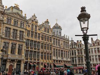 People on street against buildings in city