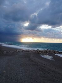 Scenic view of beach against sky during sunset