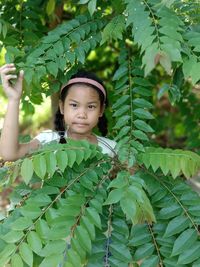 Portrait of girl with green leaves