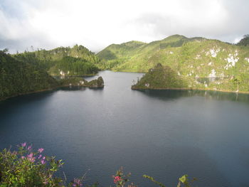 Scenic view of lake and mountains against sky