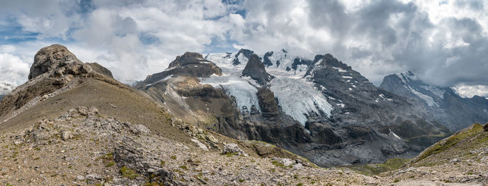 Scenic view of mountains against cloudy sky