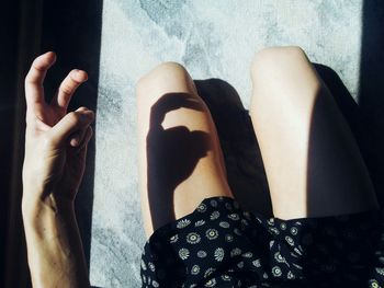 Low section of woman standing on tiled floor