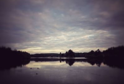 Scenic view of lake against sky at sunset