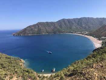 High angle view of sea and mountains against clear sky