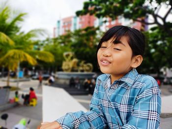 Portrait of boy smiling in city