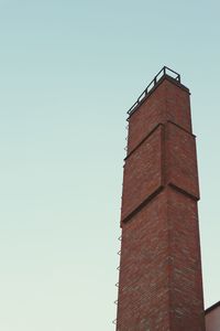 Low angle view of clock tower against clear sky