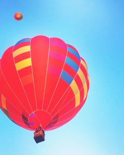 Low angle view of hot air balloon against blue sky