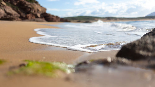 Surface level of beach against sky