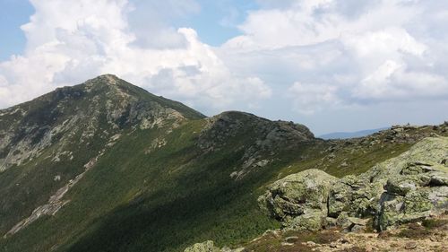 Scenic view of mountains against cloudy sky