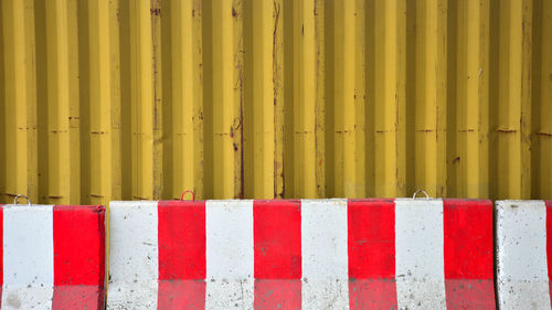 Full frame shot of metal fence against wall