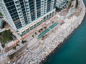 High angle view of swimming pool by building in city