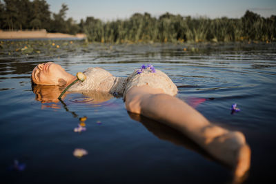 Woman in water with flowers