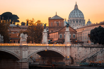 Arch bridge over canal in city, rome