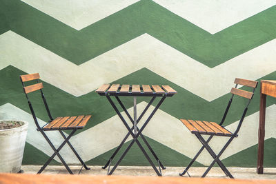 Empty chairs and table on beach