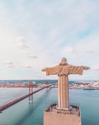 High angle view of christ the king statue against april 25th bridge over river