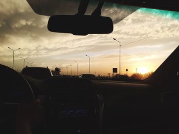 Cars on street at sunset