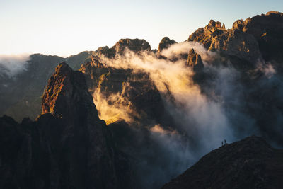 Hikers viewing the misty mountains of madeira.