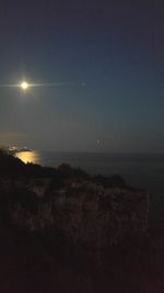 Scenic view of sea against clear sky at night