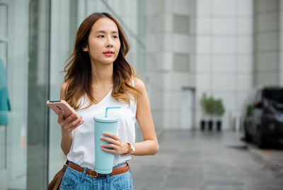Portrait of young woman using mobile phone