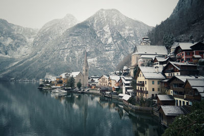 Panoramic view of townscape by mountain against sky