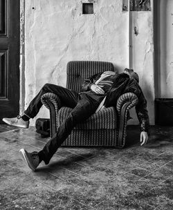 Exhausted man sleeping on armchair at home