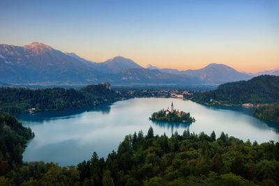 Scenic view of lake and mountains against sky