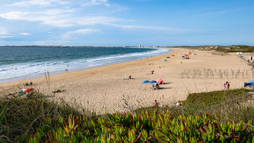 People on beach against sky