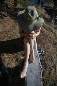 Low section of woman wearing hat