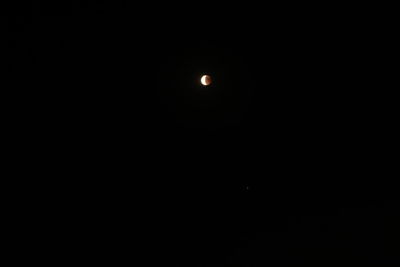 Low angle view of moon against sky at night