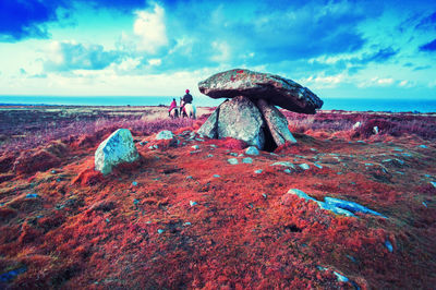 Scenic view of rocks on beach against sky