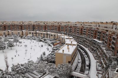 High angle view of buildings in city during winter